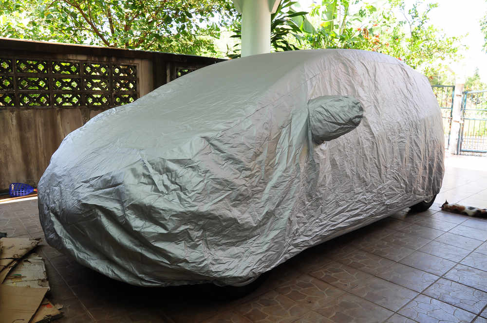 A car covered standing in a parking